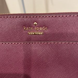Kate Spade crossbody, used once. Burgundy with black and white striped lining.